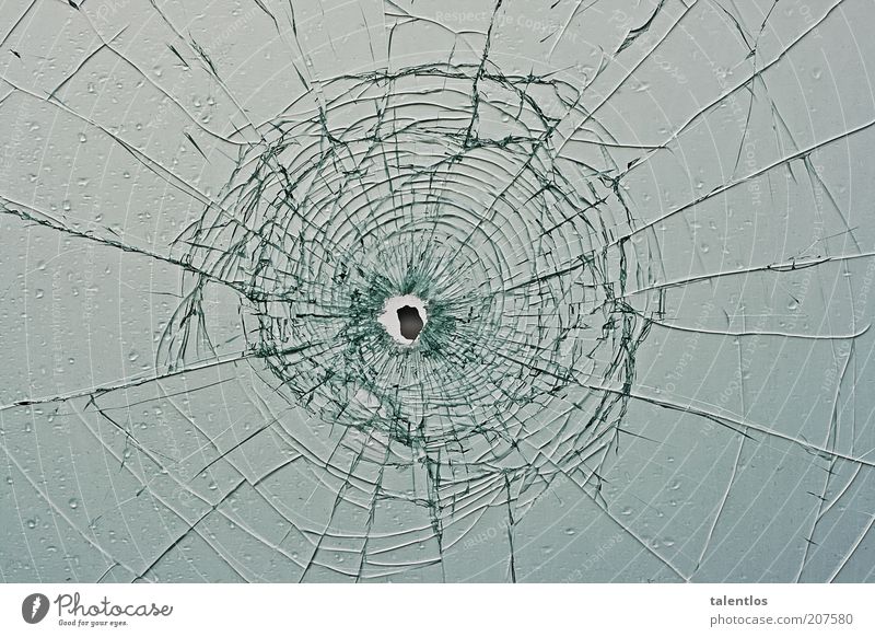 bullet hole in glass window