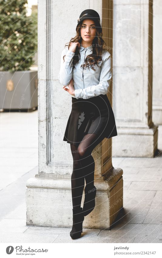 young woman in urban background wearing casual clothes - a Royalty