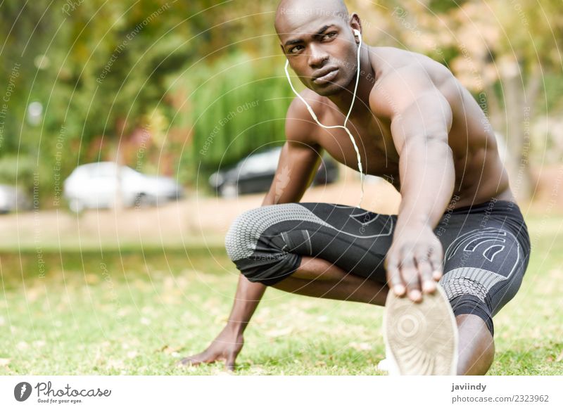 Fit shirtless young black man doing stretching - a Royalty Free Stock Photo  from Photocase