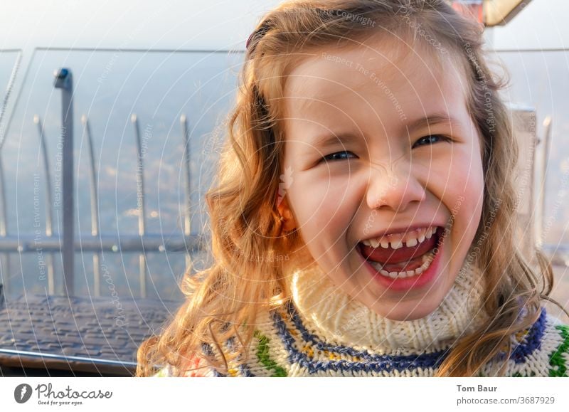 girl with curly blonde hair and blue eyes