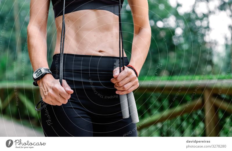 Unrecognizable Sportswoman Jumping Rope On A Bridge Stock Photo