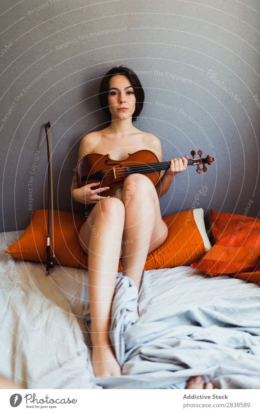 Naked woman posing with violin a Royalty Free Stock from Photocase