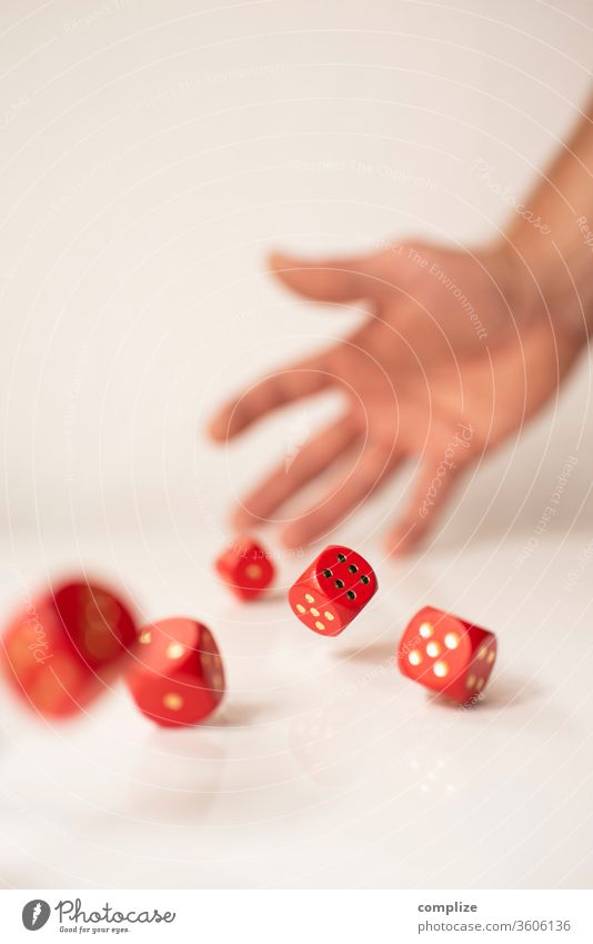 hand rolling dice on table