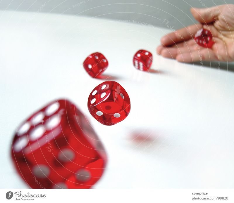 hand rolling dice on table
