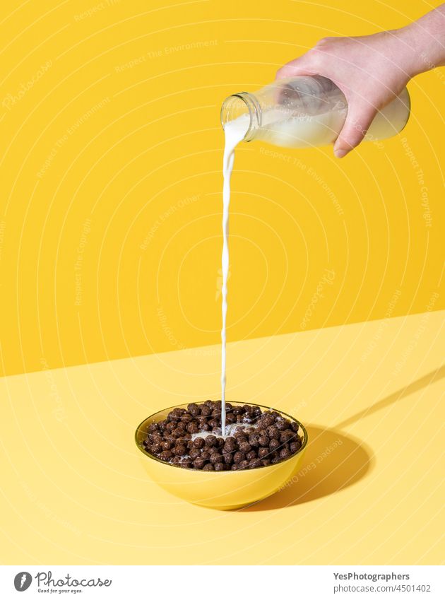 pouring milk into cereal